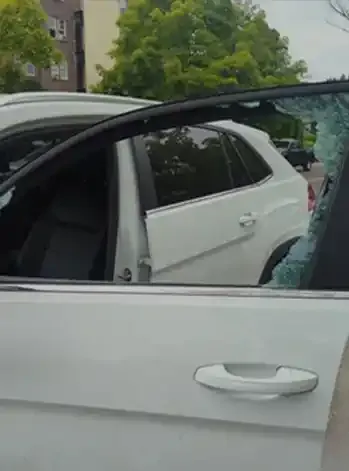 White car with broken side window Glass