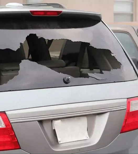 Rear of a car with a cracked, broken back glass needing rear window replacement in Palm Beach