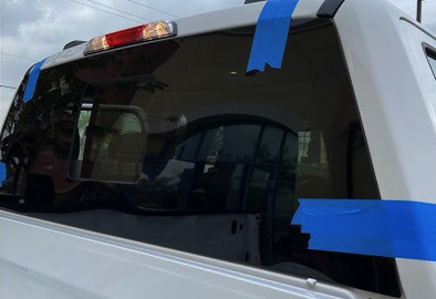 Taped rear window during mobile back glass replacement on a van in Richardson