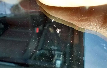 Windshield pitting from road debris sealed during Seattle windshield repair